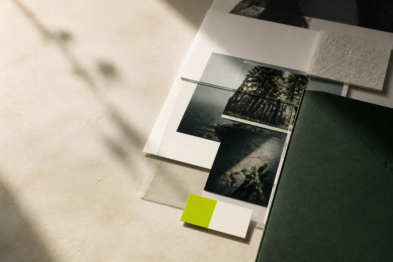 A campaign planning desk with photographs and material samples.